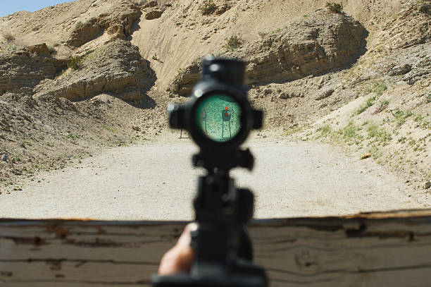 Rifle sight aiming at target on firing range