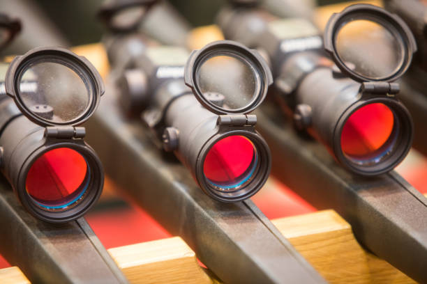 Close up shot of some rifles with scopes.